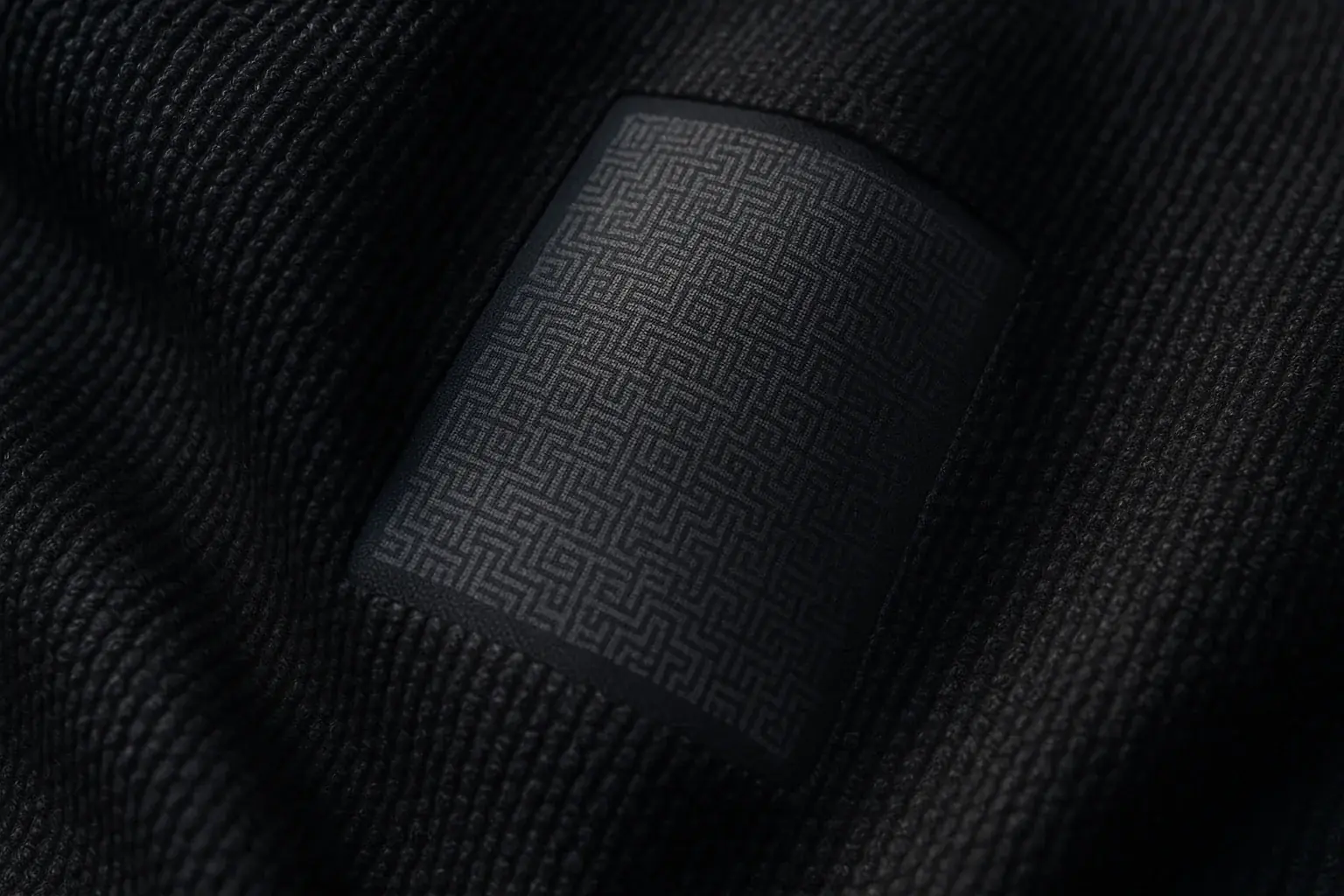 Matte E-Ink on textured fabric; ambient light and shadows create dynamic, subtle patterns that appear and disappear.